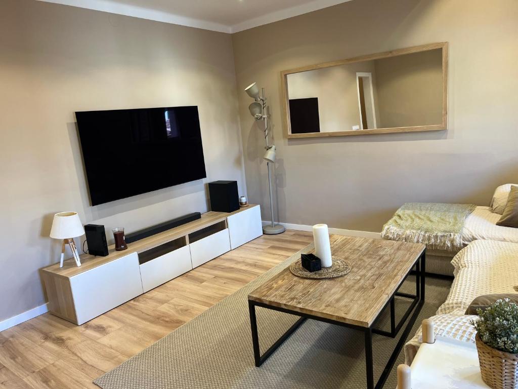 a living room with a large flat screen tv at Centro in Sant Cugat del Vallès