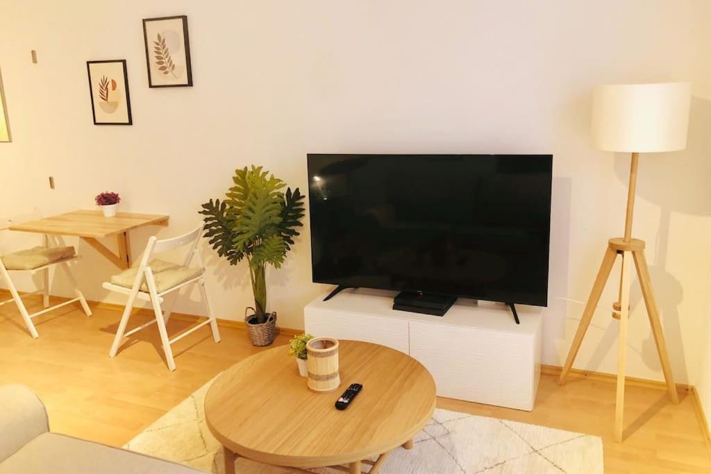 a living room with a large flat screen tv at Modernes Apartment in Waldstetten in Waldstetten