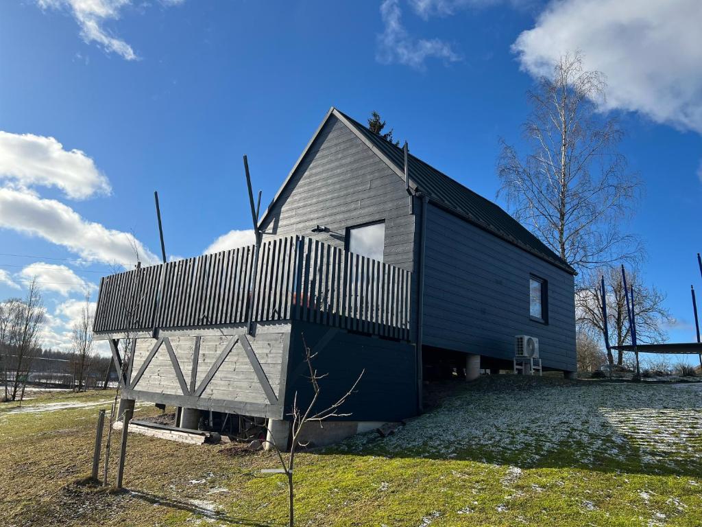 a small house with a gambrel roof with a gambrel at Bear House in Sigulda