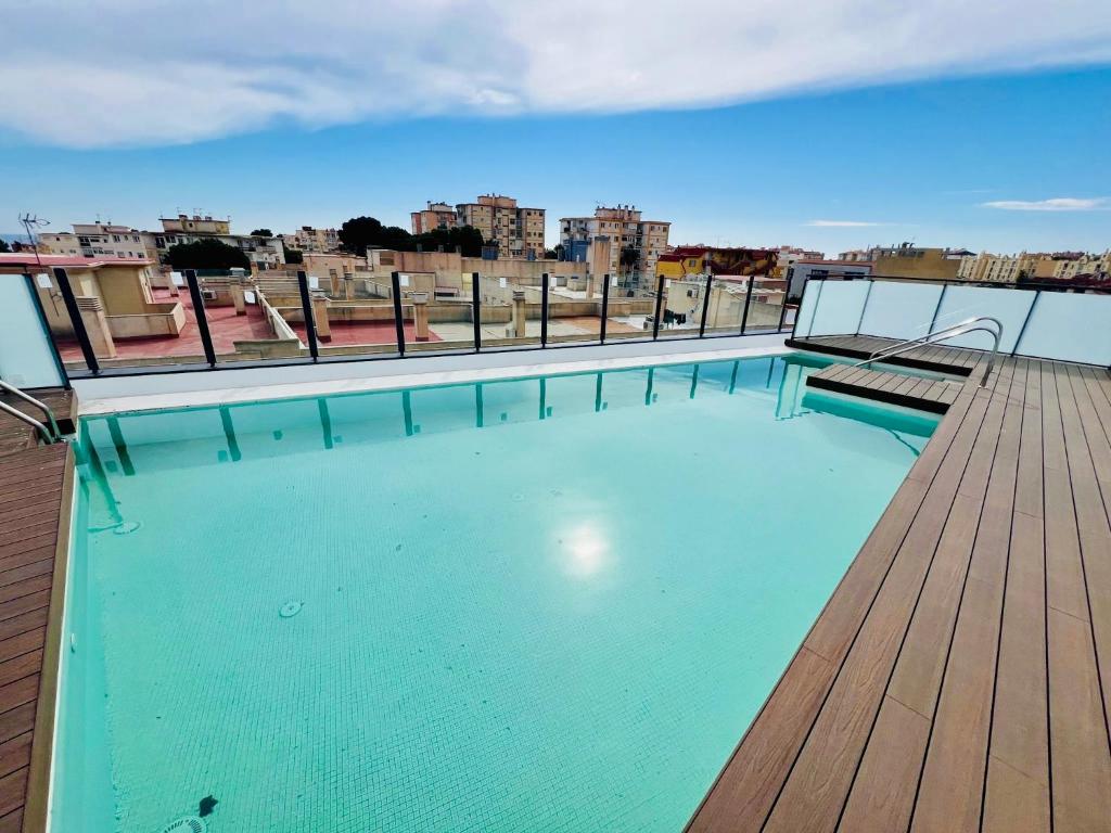 a swimming pool on the roof of a building at APTO DISEÑO CENTRO TORREMOLINOS in Torremolinos