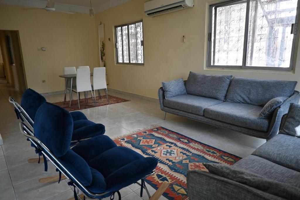 a living room with a couch and chairs and a table at Stylish Hilltop King Bed Apartment with Free Parking and Wifi in Wuţayyah