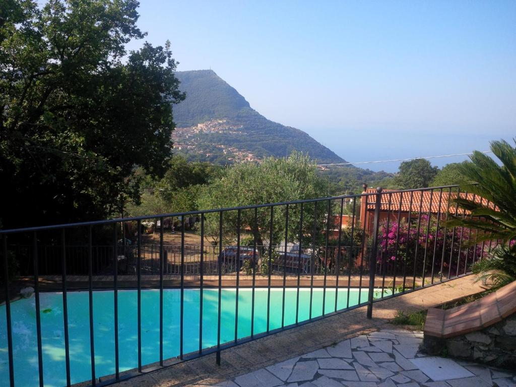 a swimming pool with a mountain in the background at Wishing Well Maratea in Maratea