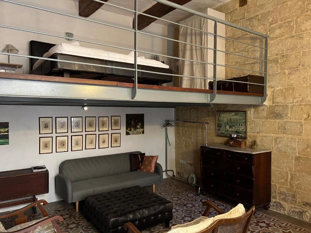 a living room with a bunk bed and a couch at Valletta Period Townhouse in Valletta