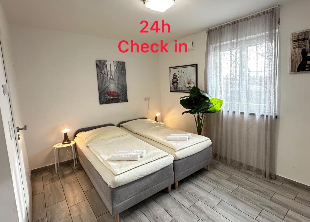 a bedroom with a bed with the words check in at Private Studio mit eigene Küche und Bad Netflix Youtube in Nuremberg