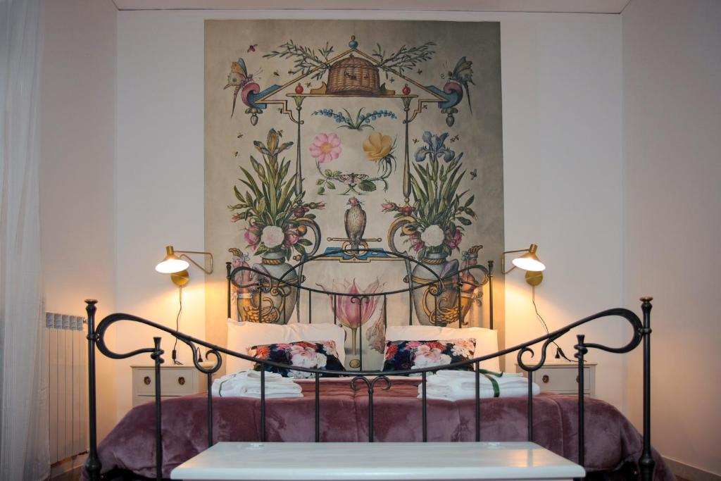エルコラーノにあるCasa Graziosaの壁画が飾られた部屋のベッド1台