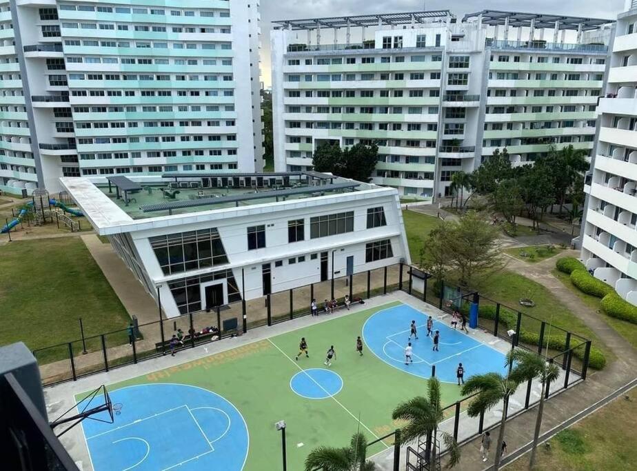 an aerial view of a basketball court in a city at Private condo w/ balcony near Batasan, Ateneo, UP, Diliman, The Residences at Commonwealth in Manila