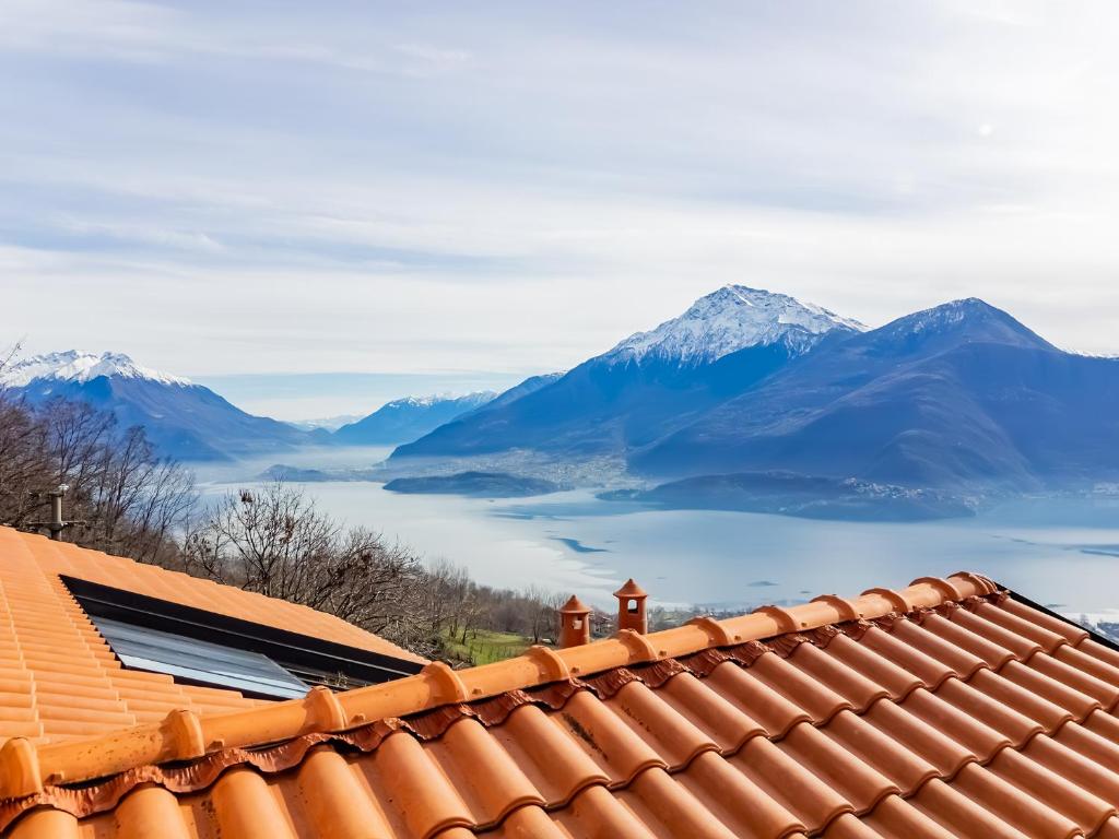 a view from the roof of a house with mountains in the background at Rododendro House - Lake View and Pool Relax in Morbio
