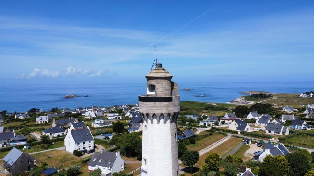 an aerial view of a lighthouse in a small town at TY COAT - Maison neuve avec vue mer, piscine et bain nordique in Saint-Pabu