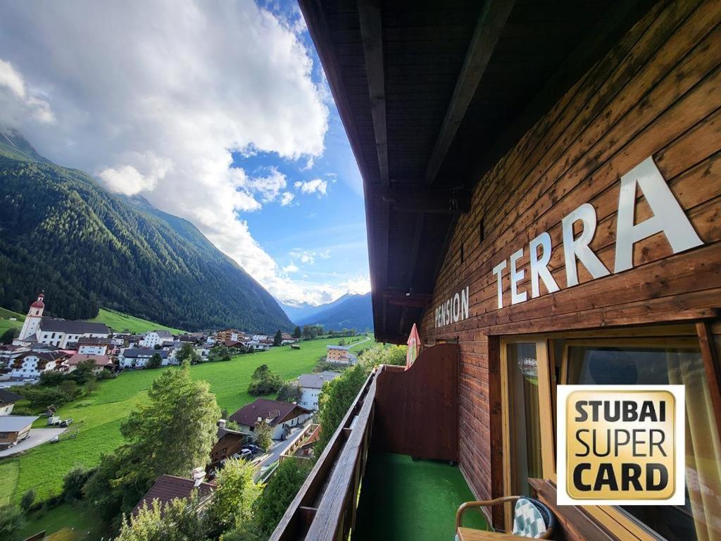 a sign on the side of a building looking at a valley at Pension Terra in Neustift im Stubaital