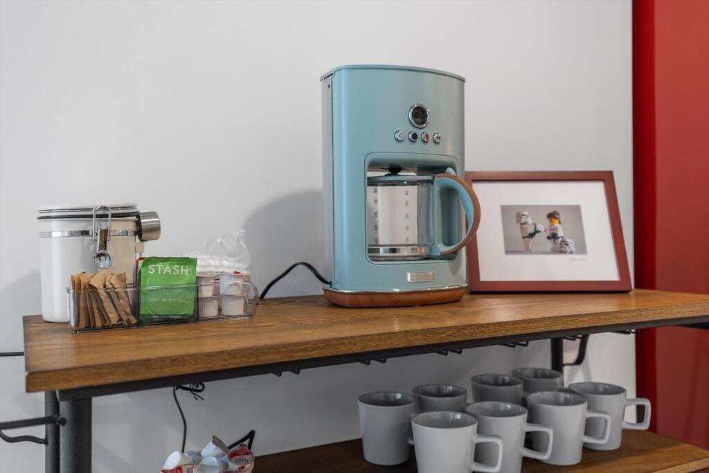 a coffee maker sitting on a wooden shelf with cups at Stone's Throw from Capitol Hill Free Parking in Washington, D.C.