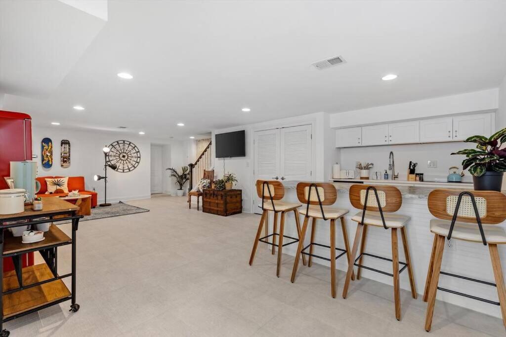 a kitchen with white cabinets and bar stools at Stone's Throw from Capitol Hill Free Parking in Washington, D.C.