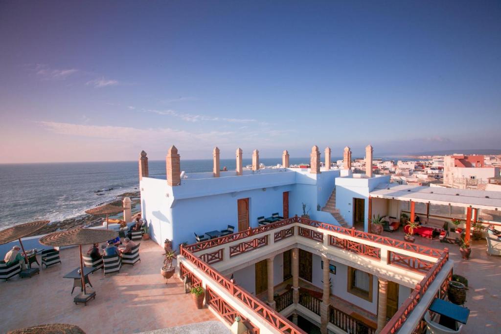a building on the beach next to the ocean at Palais Des Remparts in Essaouira
