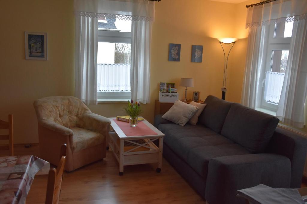 a living room with a couch and a chair and a table at Ferienwohnung Werner in Annaberg-Buchholz