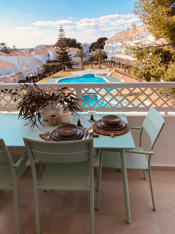 a table and chairs on a balcony with a view of a pool at Al_andalus_404 in Alcossebre