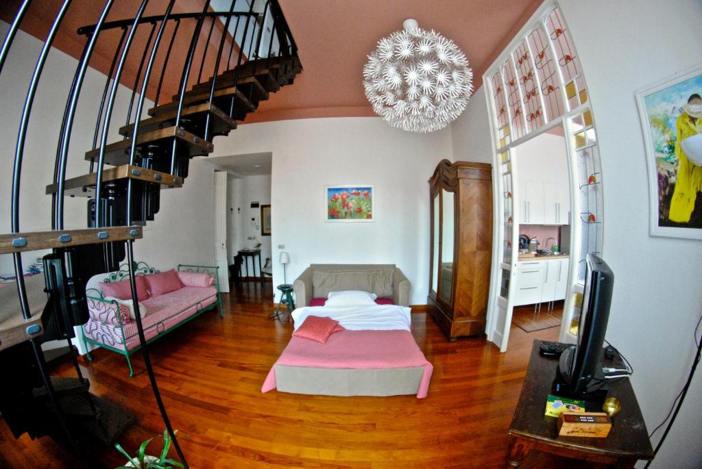 a living room with a bed and a staircase at B&B Agapantus in una Villa dell'800 in Dolceacqua