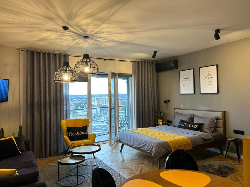 a bedroom with a bed and a living room at Capital Towers "FIRST CLASS" in Rzeszów