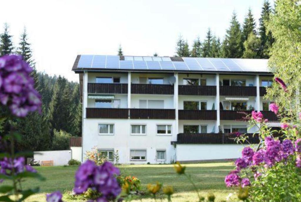 a building with solar panels on top of it at Tannenhof Wohnung 4 in Haidmühle