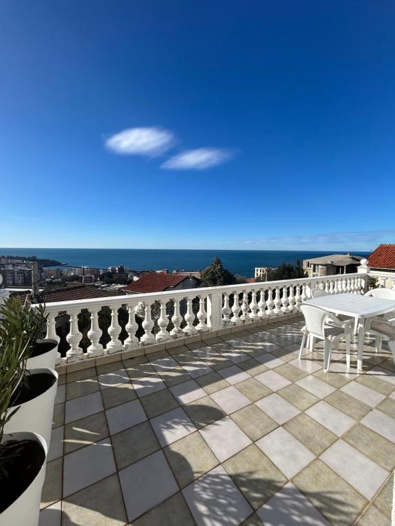 a balcony with a table and a view of the ocean at Villa Marina in Dobra Voda