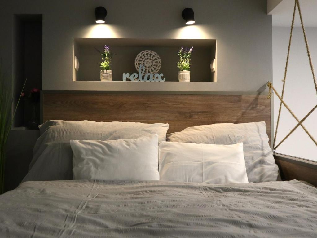 a bedroom with a bed with two potted plants above it at Romantic and relax in Esztergom