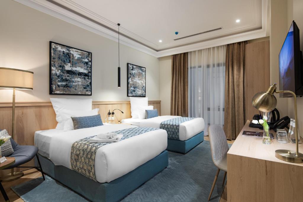 Postel nebo postele na pokoji v ubytování Marlo Hotel - فندق مارلو