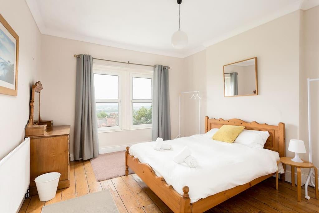 a bedroom with a large bed and a window at Large 2 story penthouse apartment, impressive views in Bristol