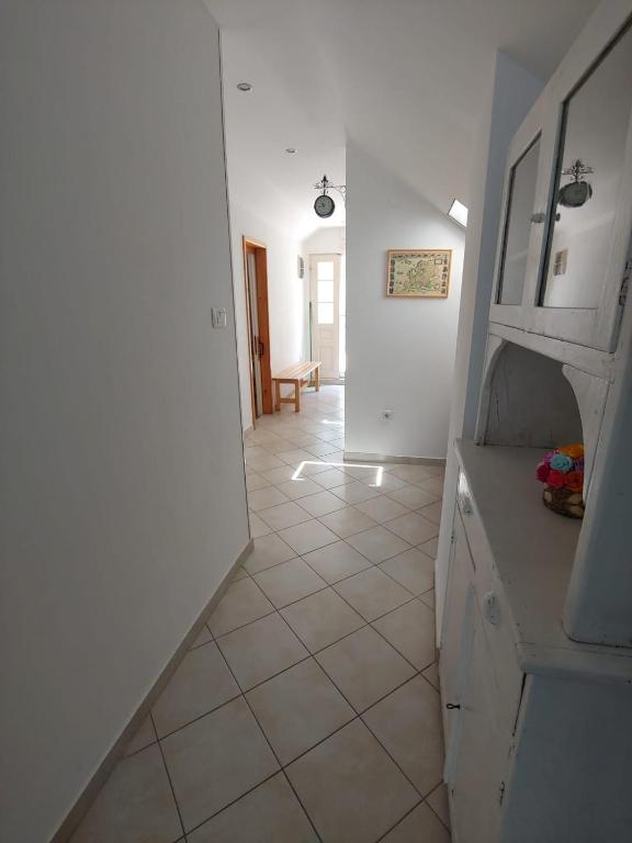 a hallway of a kitchen with a tile floor at Apartment Kumbor in Herceg-Novi