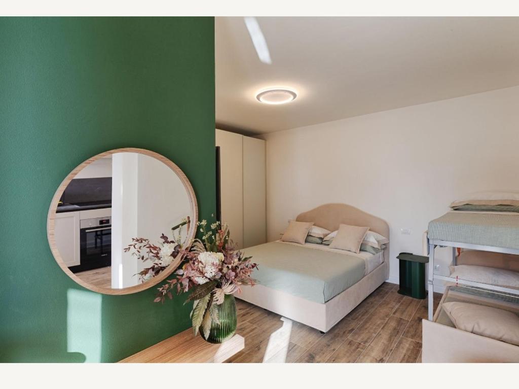 a bedroom with a bed and a mirror on the wall at Villa "LE GILDA" 5 STELLE in Massa