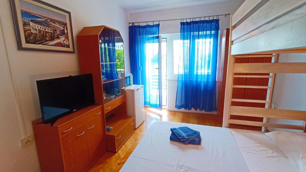 una camera con letto, TV e letto a castello di Vesna - room with private bathroom near sea a Trogir