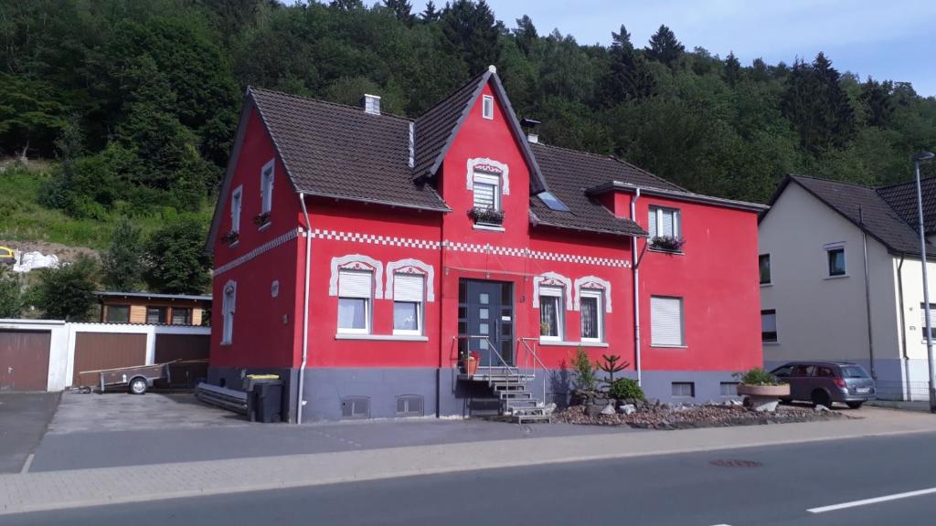 uma casa vermelha ao lado de uma rua em Wunderschönes Sauerland em Plettenberg