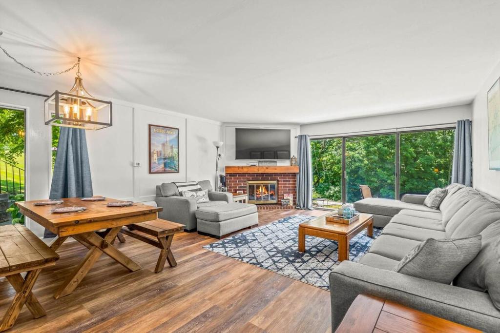 a living room with a couch and a table at Modern Lake Geneva Condo with Year-Round Views in Lake Geneva