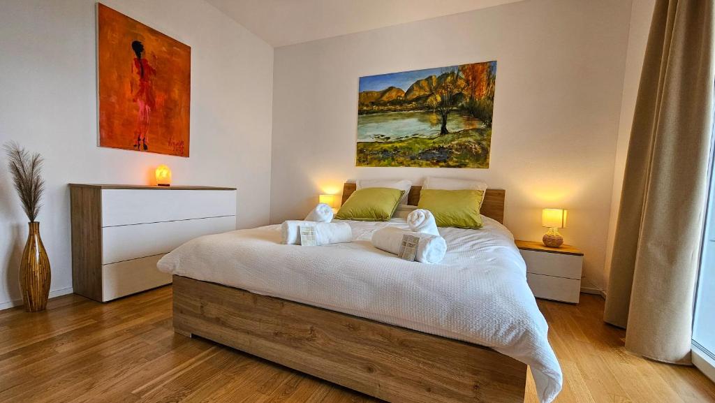 a bedroom with a bed with a painting on the wall at Bellavista Apartment with Free Parking in Lugano