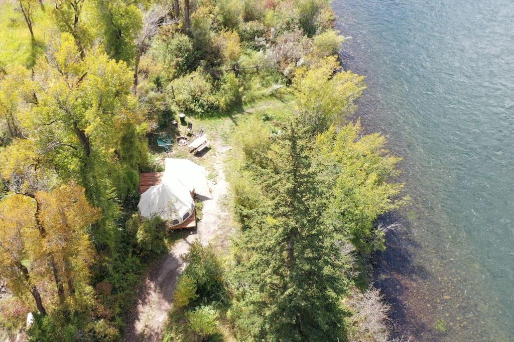 an aerial view of a house next to the water at Snake River Glamping in Irwin