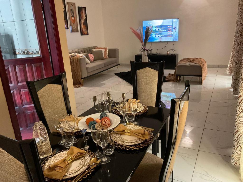 una sala da pranzo con tavolo e sedie neri di Wise Home a Douala
