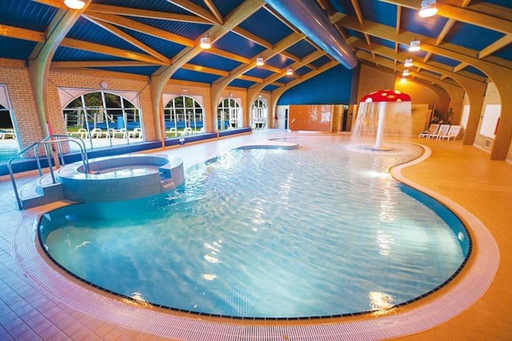 a large swimming pool in a large building at Lemon Grove in Mudeford