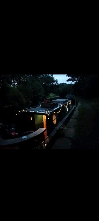 a train is traveling down a track with at Cosy, secluded narrow boat in Airton