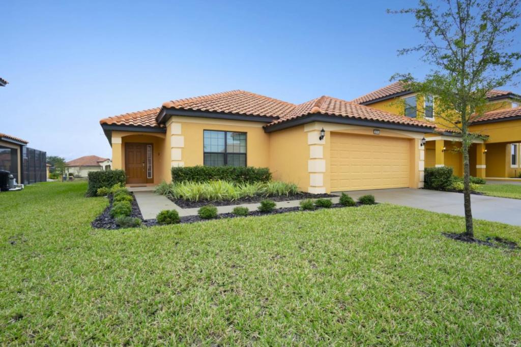 a home with a yellow house at Villa with Pool in Gated 18-hole Golf Community with self-checkin after 4pm in Davenport