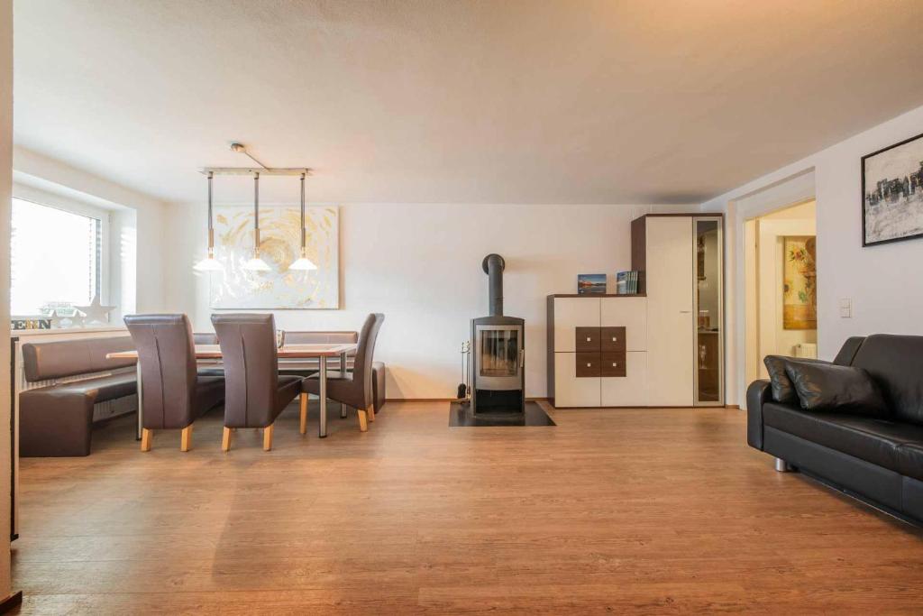 a living room with a dining table and a fireplace at Apartment Stern in Mieders in Mieders