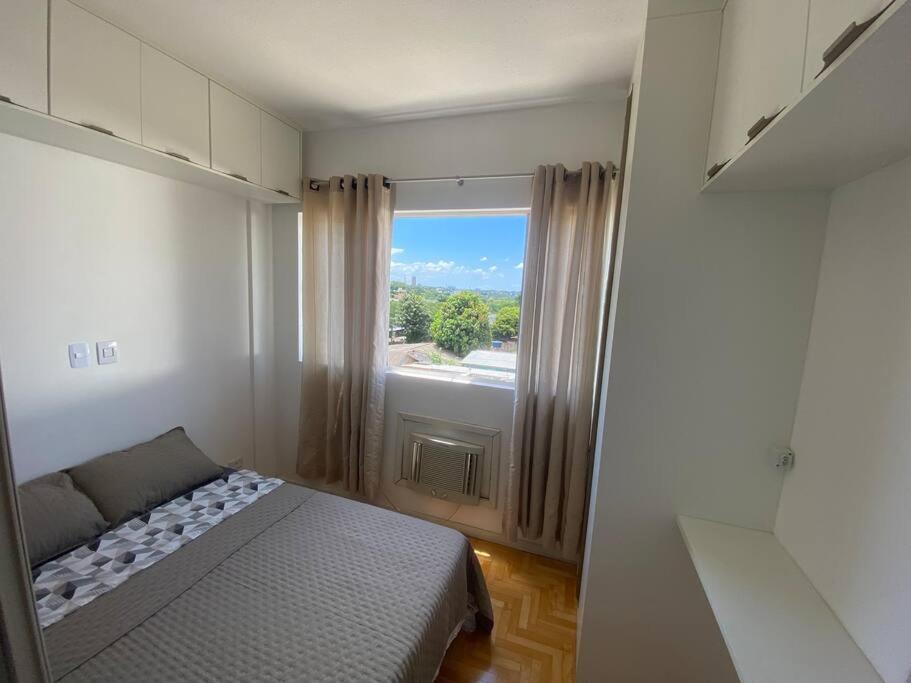 a small bedroom with a bed and a window at Studio ótima localização in Foz do Iguaçu