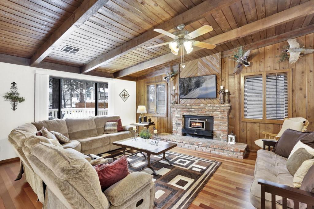 a living room with a couch and a fireplace at 2382-Belmont Pines Cottage cabin in Big Bear City