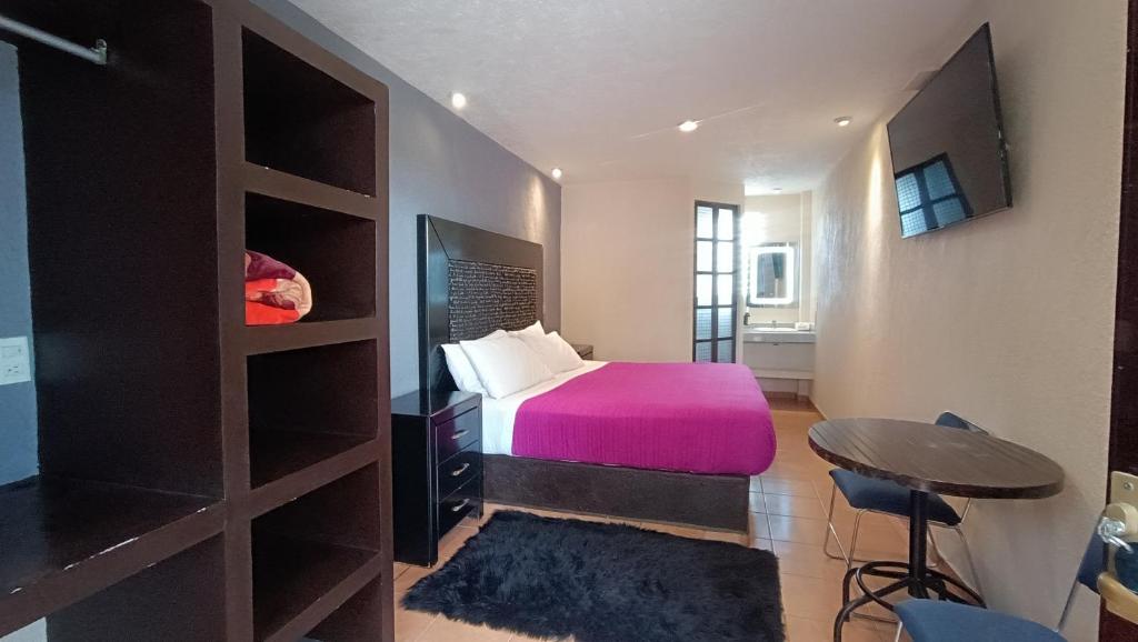 Postel nebo postele na pokoji v ubytování Hotel Real Campestre Tepetoci