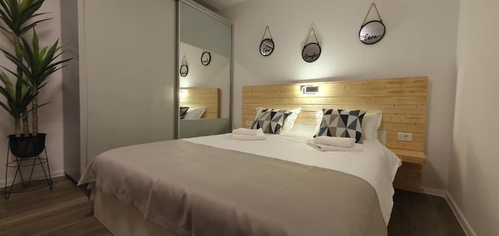 a bedroom with a large white bed and a mirror at Confort Studio 1 City Center in Bucharest