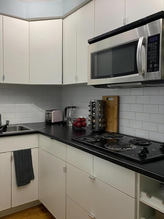 a kitchen with a stove and a microwave at Condo in Downtown in Vancouver