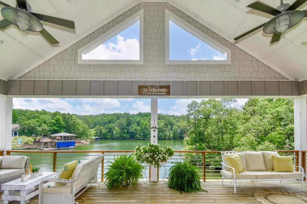 a screened in porch with a view of the water at Mallard Cove Sunsets Lake Martin in Dadeville