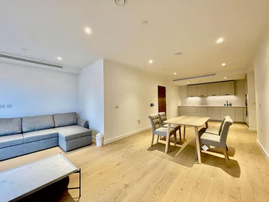 a living room with a couch and a table and chairs at Modern apartment in heart area in London