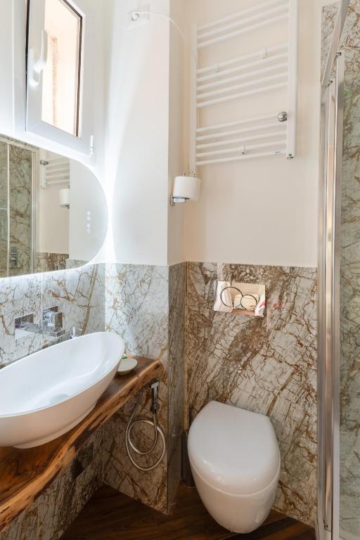 a bathroom with a sink and a toilet at Bretone XI b&b in Rome