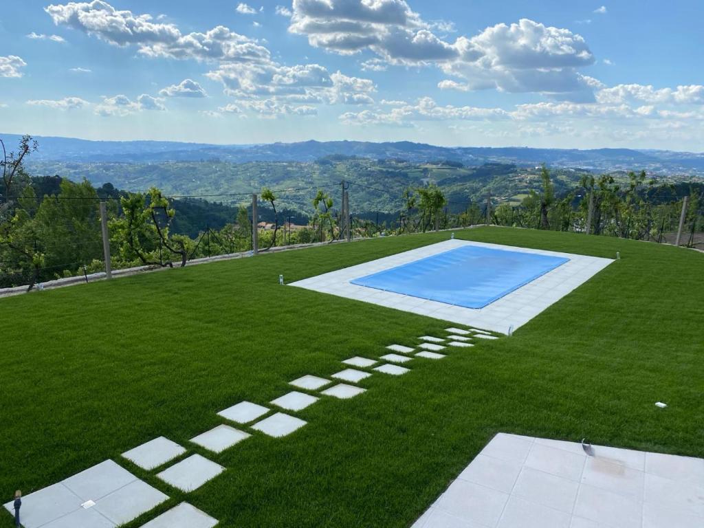 an image of a lawn with a swimming pool at Casa AURORA in Amarante