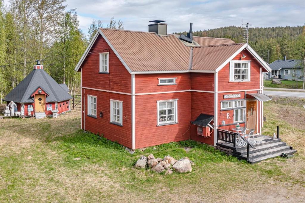 an aerial view of a red house and a small house at Midnight sun in Kittilä