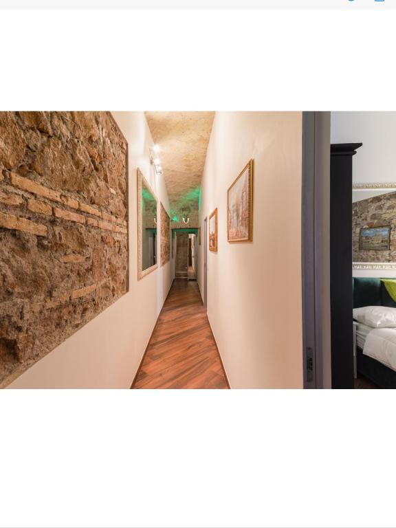 a hallway in a house with a stone wall at Bretone XI b&b in Rome