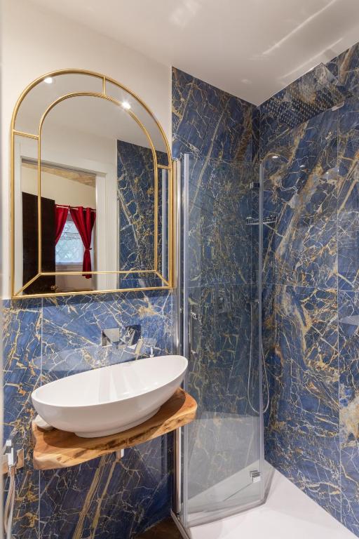 a bathroom with a sink and a mirror at Bretone XI b&b in Rome
