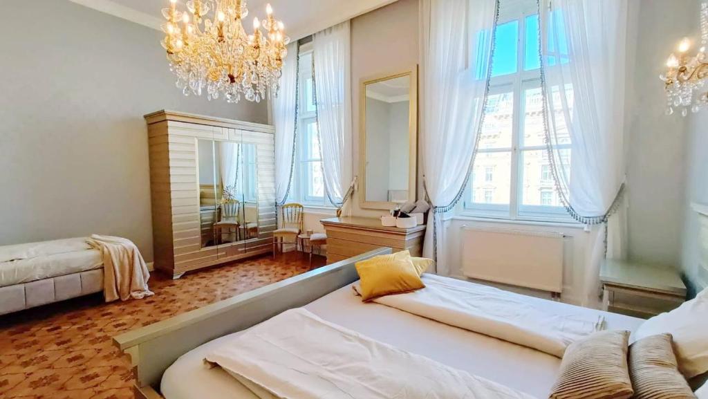 a large room with a bed and a chandelier at Luxurious apartment in the center of Vienna in Vienna